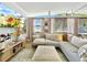 Living area with a comfortable sectional, large windows offering ample natural light, and modern decor elements at 6700 14Th N St, St Petersburg, FL 33702