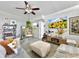 Bright living area with stylish decor, a hanging chair, and a media console with a large TV at 6700 14Th N St, St Petersburg, FL 33702