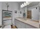 Bathroom featuring marble countertops, neutral walls, and a storage shelf for towels and decorations at 746 Coral Reef Dr # 746, Tampa, FL 33602