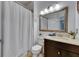 Bathroom featuring a shower with curtain and vanity with marble countertops at 746 Coral Reef Dr # 746, Tampa, FL 33602