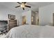 Bedroom boasts hardwood floors, a bed with tufted headboard, ceiling fan, and desk at 746 Coral Reef Dr # 746, Tampa, FL 33602