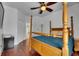 Bedroom boasts hardwood floors, a four-poster bed, and ceiling fan at 746 Coral Reef Dr # 746, Tampa, FL 33602