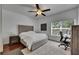 Bedroom boasts hardwood floors, a bed with tufted headboard, ceiling fan, and desk at 746 Coral Reef Dr # 746, Tampa, FL 33602