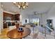 Open-concept dining area with chandelier, dark wood cabinets, and views of the bright and airy living space at 746 Coral Reef Dr # 746, Tampa, FL 33602