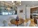 Charming dining area featuring a round table, a unique mirror wall, and elegant chandelier lighting at 746 Coral Reef Dr # 746, Tampa, FL 33602