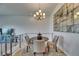 Cozy dining area with neutral decor, a modern chandelier, and a view to the outside at 746 Coral Reef Dr # 746, Tampa, FL 33602