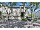 Charming home exterior featuring lush trees and a well-maintained front yard at 746 Coral Reef Dr # 746, Tampa, FL 33602