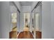 Hallway view with mirrored closet doors and access to bathrooms with marble countertops and tile flooring at 746 Coral Reef Dr # 746, Tampa, FL 33602