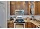 Detailed view of a kitchen with stainless steel appliances, granite countertops and custom wood cabinets at 746 Coral Reef Dr # 746, Tampa, FL 33602