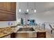 Well-designed kitchen featuring granite countertops, a stainless steel sink, and an open view to the living area at 746 Coral Reef Dr # 746, Tampa, FL 33602