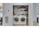 Laundry room featuring a side-by-side washer and dryer with white folding doors and built-in shelves at 746 Coral Reef Dr # 746, Tampa, FL 33602
