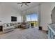 Spacious living room with high ceilings, a ceiling fan, and large window with a view of palm trees at 746 Coral Reef Dr # 746, Tampa, FL 33602