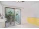Private tiled atrium with sliding glass door, bright walls and lush plants for a peaceful outdoor space at 7833 Ontario Street Cir, Sarasota, FL 34243