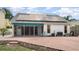 Backyard patio with screened porch, offering a relaxing outdoor space with a partial view of the lush lawn at 7833 Ontario Street Cir, Sarasota, FL 34243