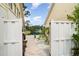 Backyard view showcasing a serene pond with a fountain feature, framed by lush greenery and a white picket fence at 7833 Ontario Street Cir, Sarasota, FL 34243