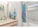 Cozy bathroom featuring a vanity with marble countertops and a tub with a shower at 7833 Ontario Street Cir, Sarasota, FL 34243