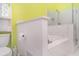 Bathroom featuring tiled tub, shower with glass door, toilet, and a storage shelf at 7833 Ontario Street Cir, Sarasota, FL 34243