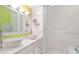 Bathroom featuring double bowl sinks, modern fixtures, and white cabinets at 7833 Ontario Street Cir, Sarasota, FL 34243