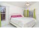 Light-filled bedroom with tile flooring and large windows, creating a comfortable and inviting space for rest and relaxation at 7833 Ontario Street Cir, Sarasota, FL 34243