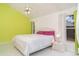 Bedroom with vaulted ceiling, ceiling fan, tile floors, and large bed with pink pillows at 7833 Ontario Street Cir, Sarasota, FL 34243