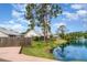 Scenic backyard featuring lush landscaping, a tranquil pond, and a fountain view at 7833 Ontario Street Cir, Sarasota, FL 34243
