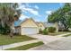 Charming single-Gathering home with well-manicured lawn and a wide driveway leading to the two-car garage at 7833 Ontario Street Cir, Sarasota, FL 34243