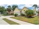 Inviting yellow home with lush landscaping and a spacious driveway, nestled in a friendly neighborhood at 7833 Ontario Street Cir, Sarasota, FL 34243