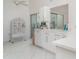 Clean, well-lit kitchen with sleek, white cabinetry and view to outdoor patio at 7833 Ontario Street Cir, Sarasota, FL 34243