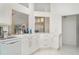 Bright white kitchen with modern appliances and an open design, creating a welcoming and functional cooking space at 7833 Ontario Street Cir, Sarasota, FL 34243
