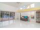 Bright living room showcasing high ceilings, tile floors, and a serene lake view, creating a tranquil living environment at 7833 Ontario Street Cir, Sarasota, FL 34243