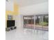 Bright living room with high ceilings, tile flooring, and sliding glass doors, creating an inviting and open space at 7833 Ontario Street Cir, Sarasota, FL 34243