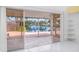 View from the sliding glass doors to the outside patio, showcasing a beautiful pond at 7833 Ontario Street Cir, Sarasota, FL 34243