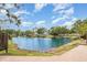 Breathtaking tranquil view of the community pond and fountain surrounded by lush mature trees at 7833 Ontario Street Cir, Sarasota, FL 34243