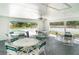 A shared pool house is ready for your next pool party with ample seating near the pool and tennis courts at 7833 Ontario Street Cir, Sarasota, FL 34243