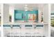 Relax at the poolside bar featuring a sink, white tile counters, storage and four chairs at 7833 Ontario Street Cir, Sarasota, FL 34243