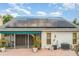 Rear view of the property highlighting the solar panels on the roof above the brick patio with screened in porch at 7833 Ontario Street Cir, Sarasota, FL 34243