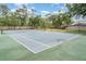 Enjoy a game of tennis on this well-maintained community tennis court with green and blue surface at 7833 Ontario Street Cir, Sarasota, FL 34243