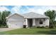 Charming single-story home with a two-car garage, manicured lawn, and inviting front entrance at 7881 Lakes Edge Ln, Port Charlotte, FL 33981