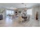 Open-concept living and dining area with stylish furnishings, tray ceiling, and serene views at 7881 Lakes Edge Ln, Port Charlotte, FL 33981