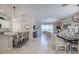 Spacious living and dining area featuring neutral tones, tile floors, and sliding glass doors to a lanai at 7881 Lakes Edge Ln, Port Charlotte, FL 33981