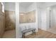 Elegant bathroom with a tiled shower, glass enclosure, seating, and neutral tones at 7922 Lakes Edge Ln, Port Charlotte, FL 33981