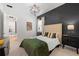 Spacious bedroom with a dark accent wall and a geometric light fixture at 7922 Lakes Edge Ln, Port Charlotte, FL 33981