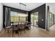 This dining room features a dark accent wall and an elegant chandelier and offers outdoor views at 7922 Lakes Edge Ln, Port Charlotte, FL 33981