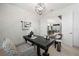 Bright office space featuring a modern desk, geometric light fixture and a view into the open floor plan at 7922 Lakes Edge Ln, Port Charlotte, FL 33981
