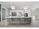 Bright, open kitchen with a large center island, modern appliances, and ample counter space at 7970 Lakes Edge Ln, Port Charlotte, FL 33981
