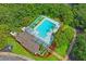 An aerial view of the community pool and barbecue area surrounded by mature trees and well-manicured landscaping at 802 Antler Ct, Brandon, FL 33511