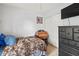 Cozy bedroom with a closet, TV, dresser, and a baseball themed wall decoration at 802 Antler Ct, Brandon, FL 33511
