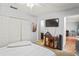 A bedroom featuring a closet, tv, and entryway to a bathroom and living room at 802 Antler Ct, Brandon, FL 33511