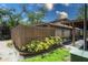 Home exterior featuring wood fence, green landscaping, and reserved parking at 802 Antler Ct, Brandon, FL 33511