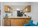 Kitchen featuring granite counters, wood cabinets, and breakfast bar at 802 Antler Ct, Brandon, FL 33511